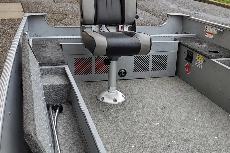 Slide: The Image of 2015 Lund 1600 Fury Tiller boat interior with swivel seat and storage compartments. - 8
