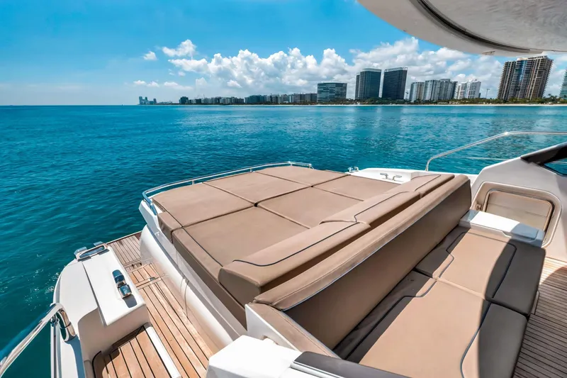 Slide: The Image of Luxurious 2018 Fairline Targa 53 OPEN yacht with sunbed, ocean view, and city skyline. - 11