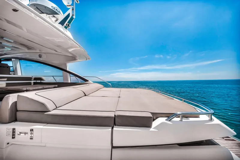 Slide: The Image of 2018 Fairline Targa 53 OPEN yacht with sunbed, ocean view, and clear blue sky. - 12