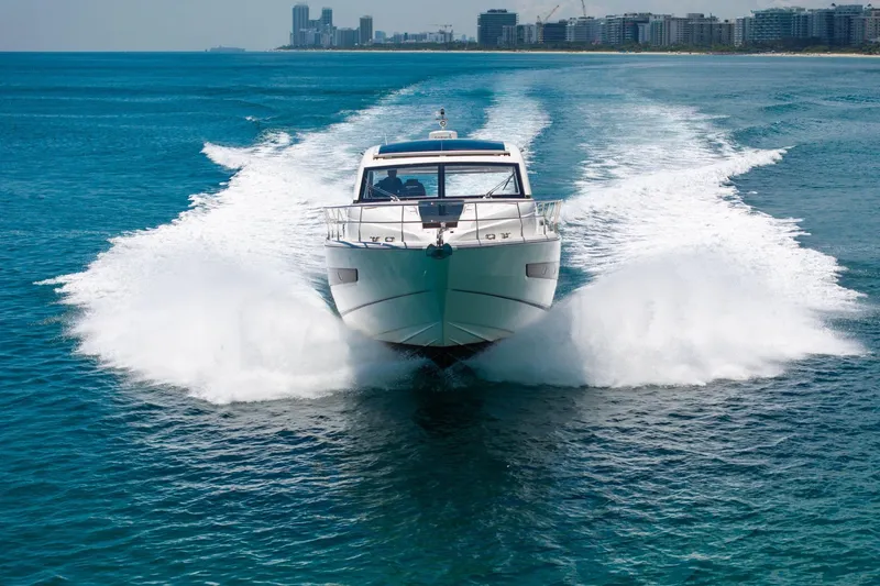 Slide: The Image of 2018 Fairline Targa 53 OPEN yacht cruising on blue ocean near city skyline. - 55