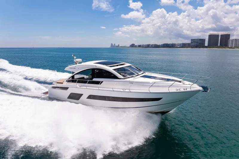 Slide: The Image of 2018 Fairline Targa 53 OPEN yacht cruising on blue ocean near city skyline. - 56