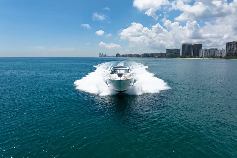 Slide: The Image of 2018 Fairline Targa 53 OPEN yacht cruising on blue ocean near city skyline. - 6