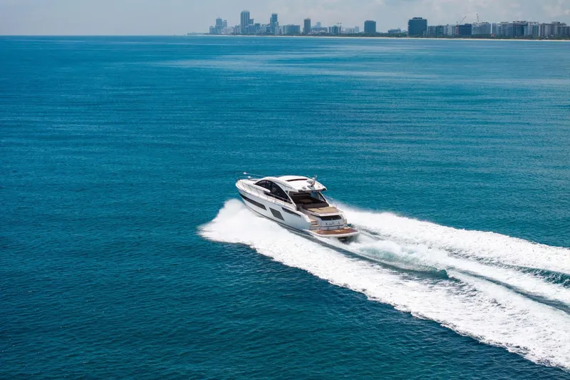Slide: The Image of 2018 Fairline Targa 53 OPEN yacht cruising on open blue sea near city skyline. - 7