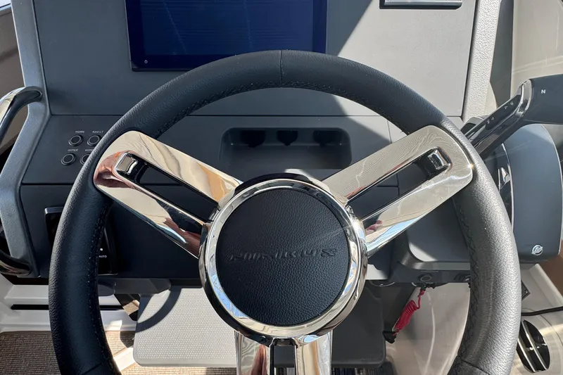 Slide: The Image of Steering wheel of 2025 Nimbus Commuter 9, featuring sleek chrome and leather design. - 13