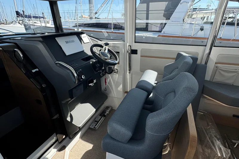 Slide: The Image of Interior of 2025 Nimbus Commuter 9 boat with modern helm and seating. - 14