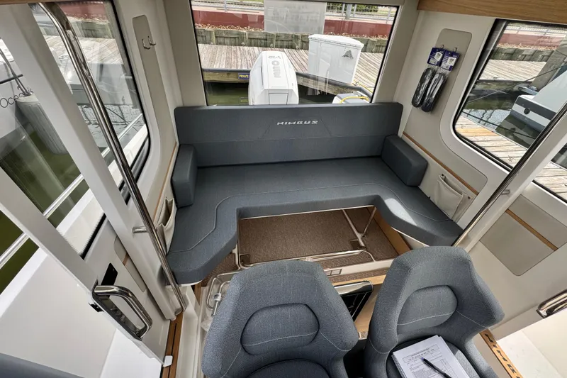 Slide: The Image of Interior of 2025 Nimbus Commuter 9 boat with gray seating and modern design. - 15