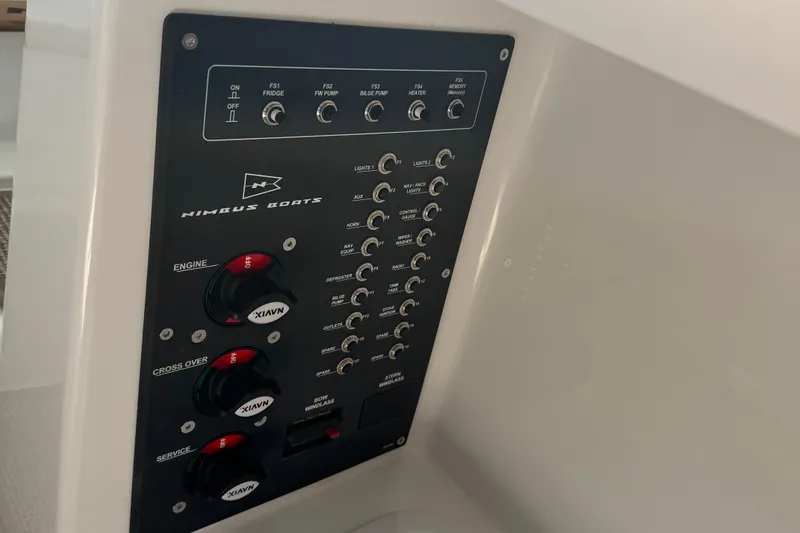 Slide: The Image of Control panel of 2025 Nimbus Commuter 9 boat with switches and dials. - 19