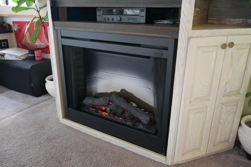 Slide: The Image of Interior of 1996 STARDUST Cruiser with kitchen, bar stools, and blue sofa. - 11
