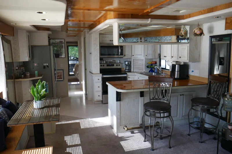 Slide: The Image of Interior of 1996 STARDUST Cruiser with helm, fireplace, and plants. Cozy and nautical design. - 12