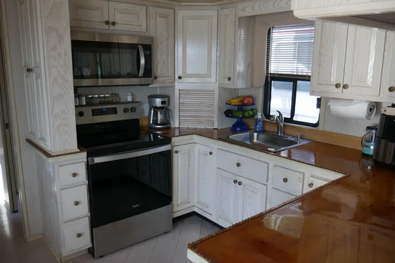 Slide: The Image of Cozy 1996 STARDUST Cruiser interior with dining area, plants, and modern kitchen. - 16