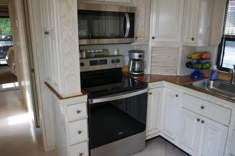 Slide: The Image of Cozy dining nook with wooden table, bench seating, and decorative pillows in a STARDUST Cruiser, 1996. - 17