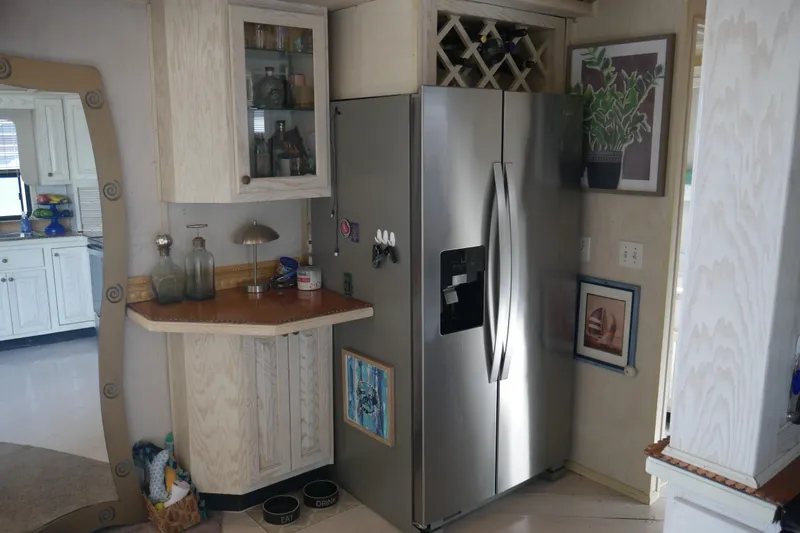 Slide: The Image of 1996 STARDUST Cruiser kitchen with modern appliances and white cabinetry. - 19