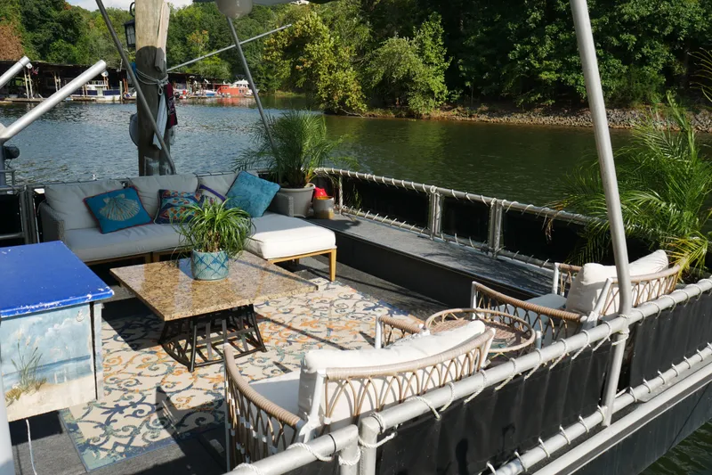 Slide: The Image of 1996 Stardust Cruisers houseboat docked, featuring sleek design and large windows. - 3