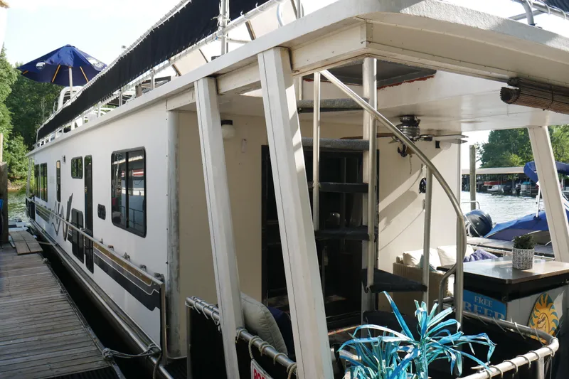Slide: The Image of Bathroom vanity in 1996 Stardust Cruisers houseboat, featuring sink, mirror, and storage cabinets. - 35