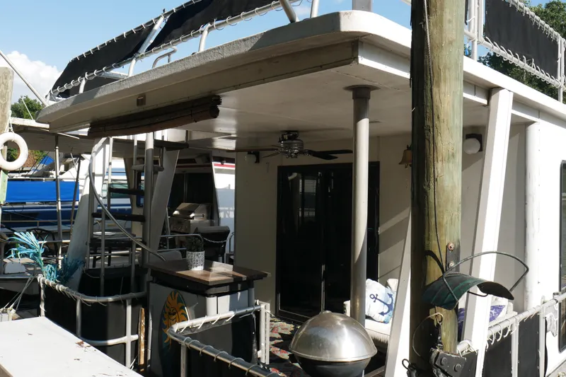 Slide: The Image of Cozy 1996 STARDUST Cruiser boat interior with seating, rug, and river view. - 37