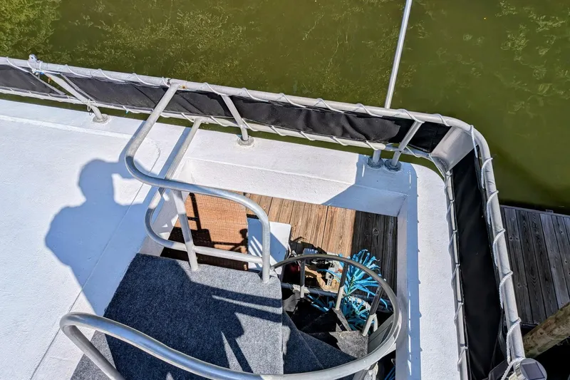 Slide: The Image of 1996 STARDUST Cruiser boat interior with spiral staircase and outdoor seating area. - 39
