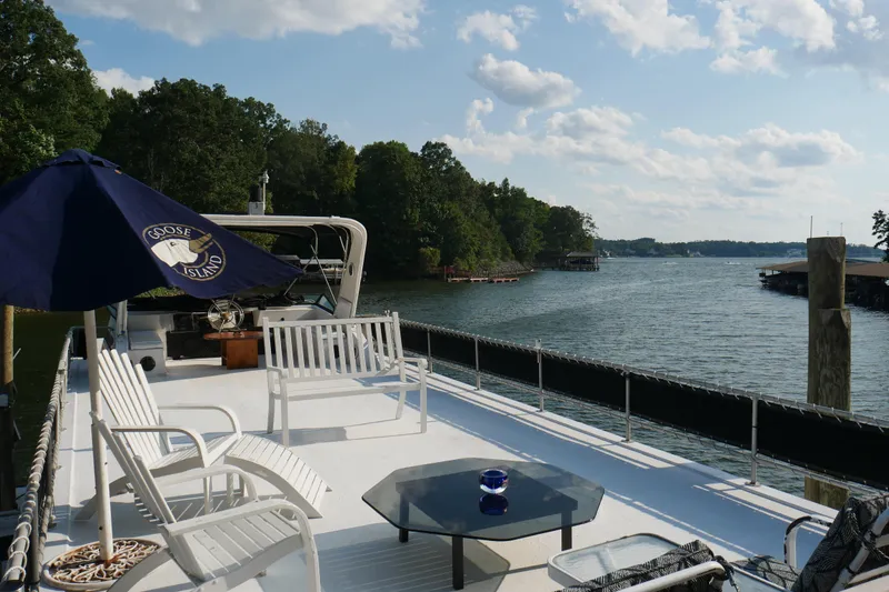 Slide: The Image of Two lounge chairs and a table on a 1996 STARDUST Cruiser deck. - 47