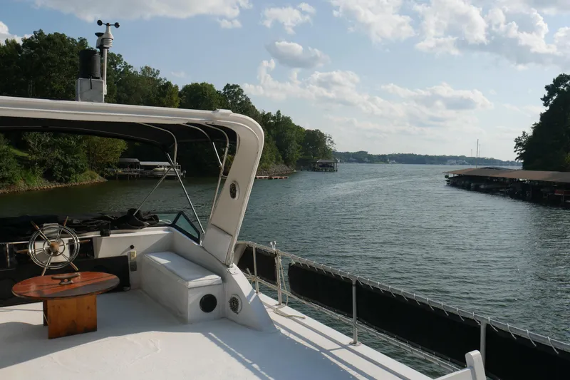 Slide: The Image of Deck of 1996 STARDUST Cruiser with white chairs, table, and umbrella. - 49