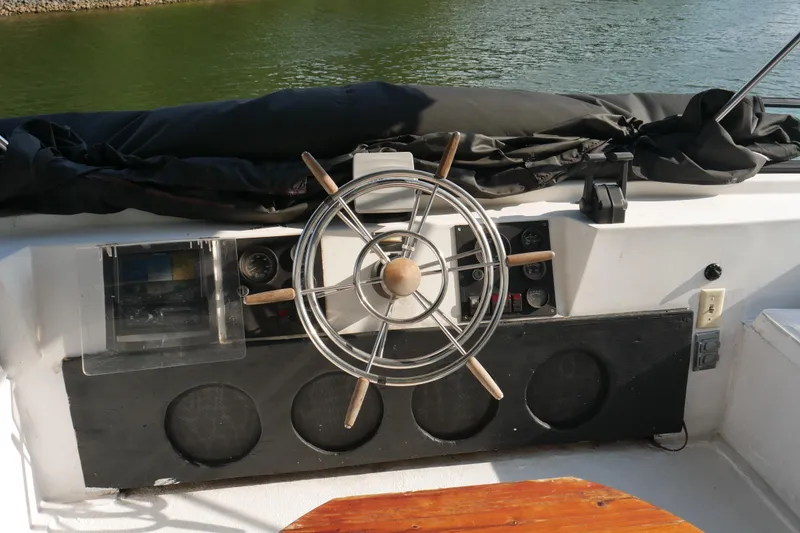 Slide: The Image of Rooftop deck of 1996 STARDUST Cruiser with seating and umbrellas, surrounded by lush greenery. - 50