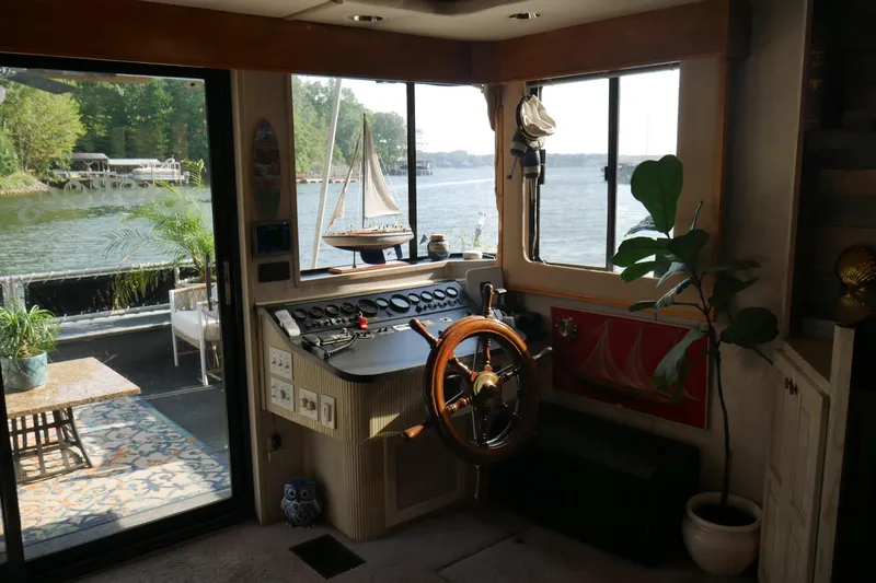 Slide: The Image of Houseboat deck with seating, plants, and lake view; STARDUST Cruiser, 1996 model. - 6