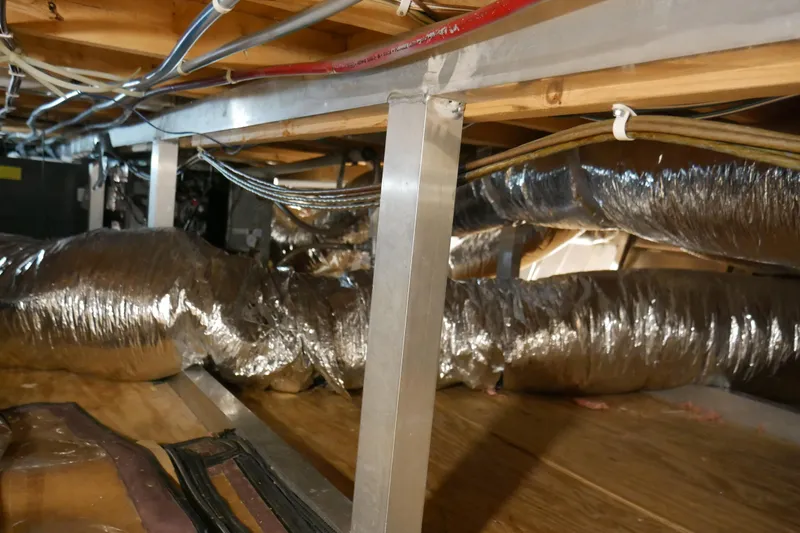 Slide: The Image of Crawl space with insulated ductwork and wiring in a 1996 STARDUST Cruiser. - 63