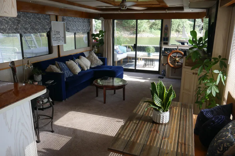 Slide: The Image of Interior of a 1996 STARDUST Cruiser boat with helm, lake view, and nautical decor. - 8