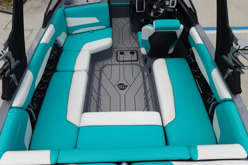 Slide: The Image of 2021 Malibu Wakesetter 22 LSV interior with teal and white seating, modern design. - 10
