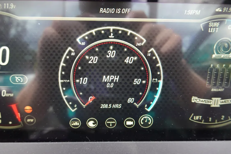 Slide: The Image of Dashboard display of a 2021 Malibu Wakesetter 22 LSV showing speedometer and controls. - 13