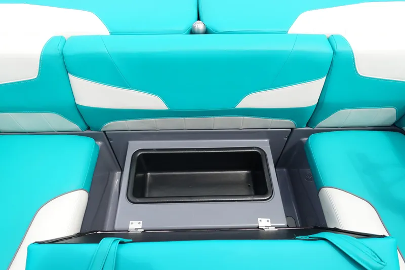 Slide: The Image of 2021 Malibu Wakesetter 22 LSV interior with teal and white seating, open storage compartment. - 17