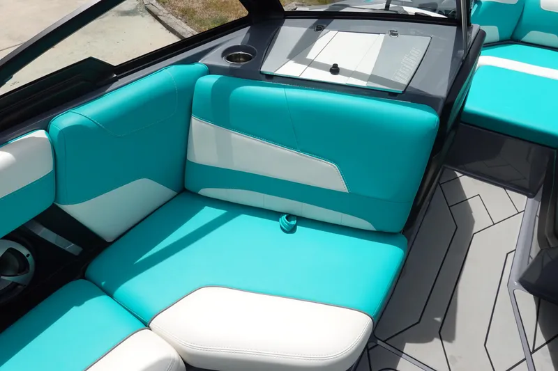 Slide: The Image of 2021 Malibu Wakesetter 22 LSV interior with turquoise and white seating. - 23