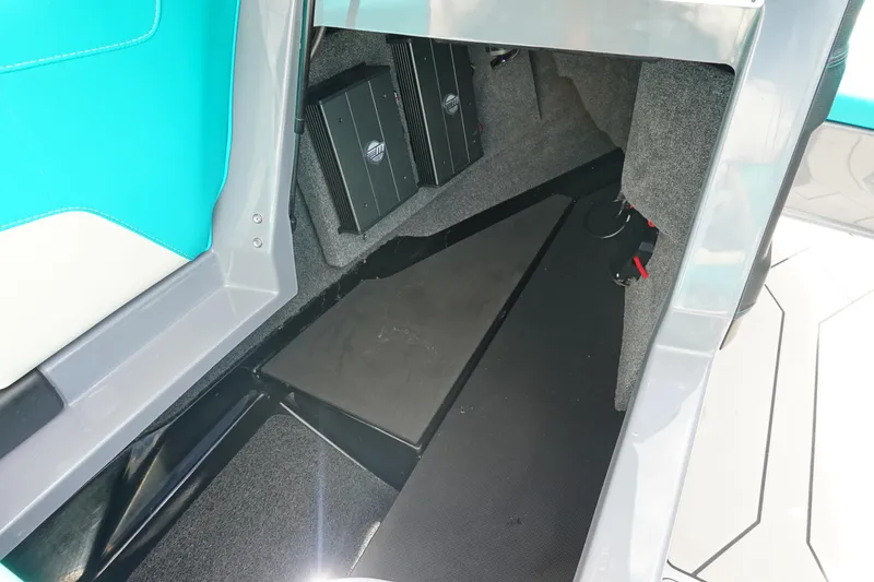 Slide: The Image of 2021 Malibu Wakesetter 22 LSV interior storage compartment with audio equipment. - 24