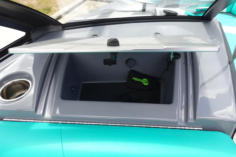 Slide: The Image of 2021 Malibu Wakesetter 22 LSV storage compartment with cup holder and branded accessory. - 26