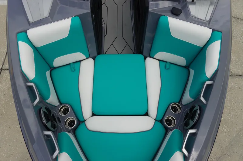 Slide: The Image of 2021 Malibu Wakesetter 22 LSV interior with teal and white seating, cup holders, and speakers. - 30
