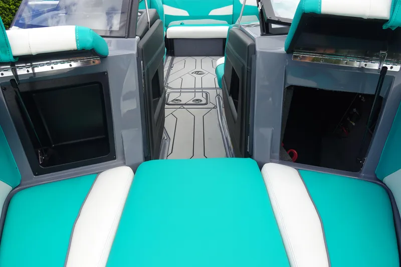 Slide: The Image of 2021 Malibu Wakesetter 22 LSV interior with teal and white seating, gray flooring. - 31