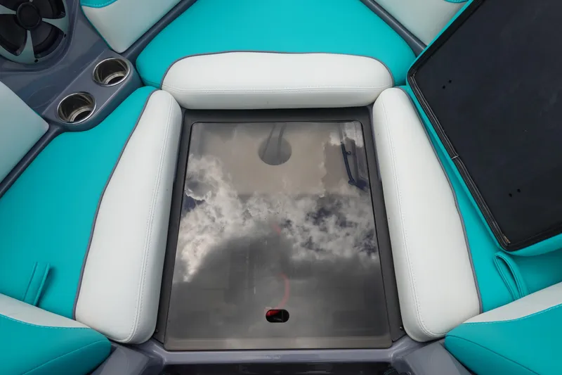 Slide: The Image of 2021 Malibu Wakesetter 22 LSV interior with teal and white seating, cup holders, and reflective panel. - 32