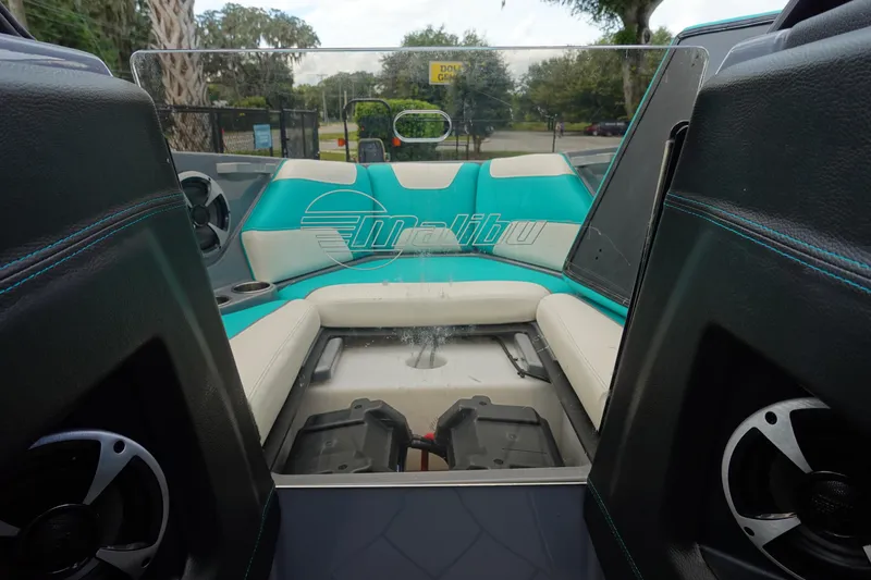 Slide: The Image of 2021 Malibu Wakesetter 22 LSV interior with teal and white seating, speakers visible. - 33