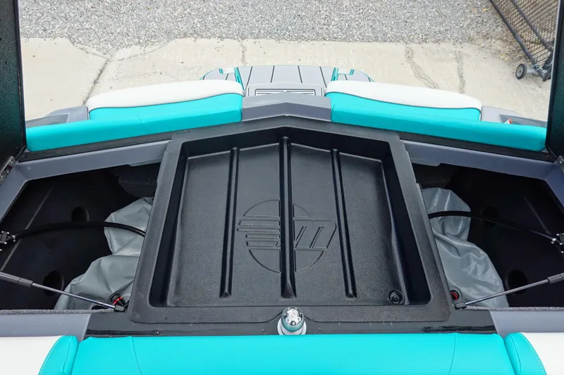 Slide: The Image of 2021 Malibu Wakesetter 22 LSV storage compartment with teal and white seating. - 35