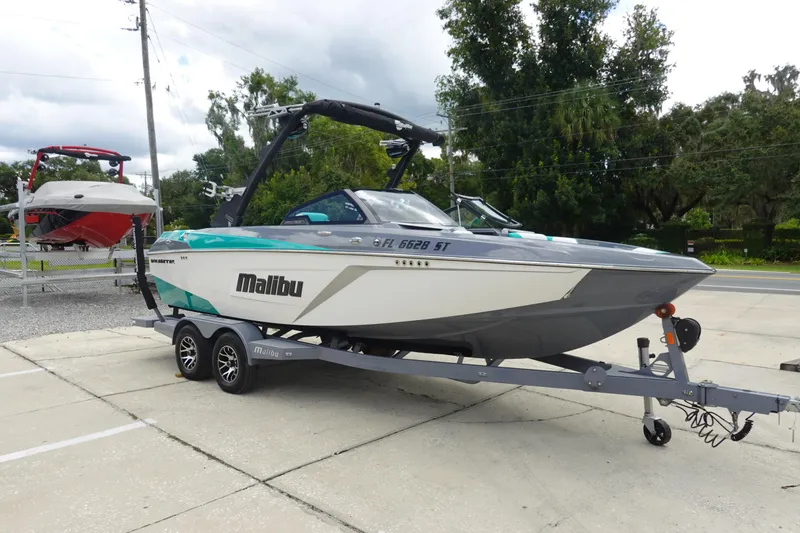 Slide: The Image of 2021 Malibu Wakesetter 22 LSV boat on trailer, parked outdoors. - 4