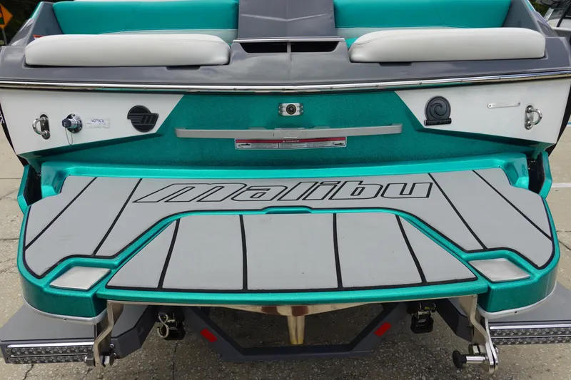 Slide: The Image of 2021 Malibu Wakesetter 22 LSV boat rear view with teal and gray accents. - 6