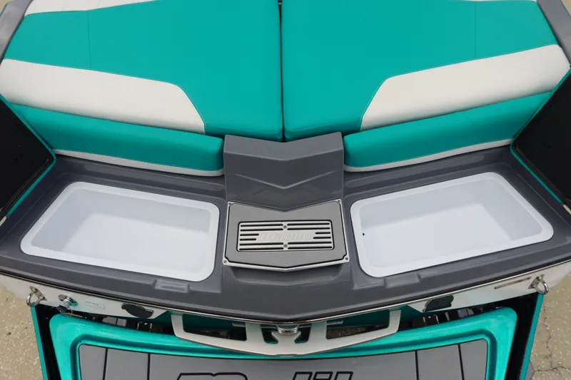 Slide: The Image of 2021 Malibu Wakesetter 22 LSV boat interior with teal and white seating and storage compartments. - 9