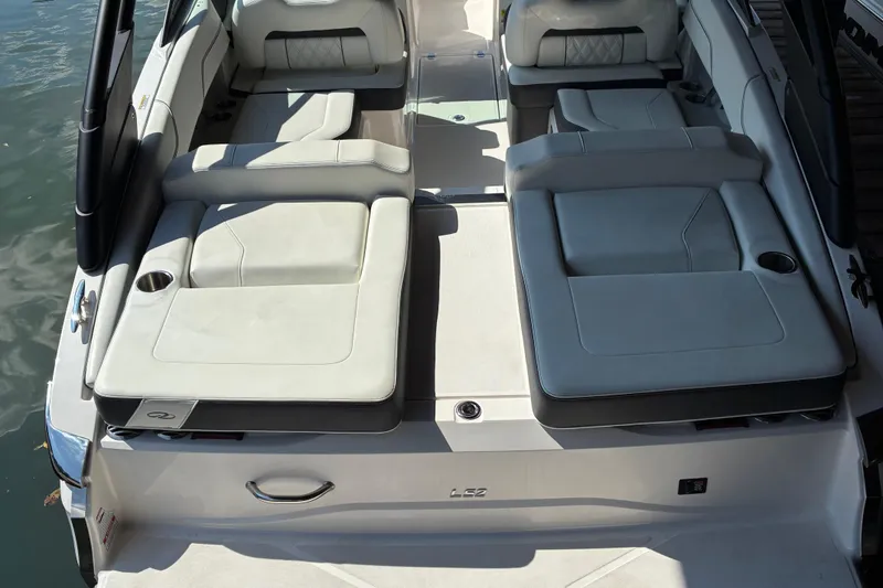 Slide: The Image of 2025 Regal LS2 boat interior with luxurious seating and cup holders on the water. - 11