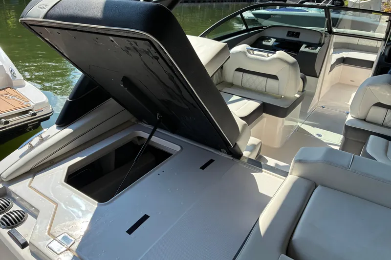 Slide: The Image of 2025 Regal LS2 boat interior with open storage compartment, luxurious seating, and modern design. - 17