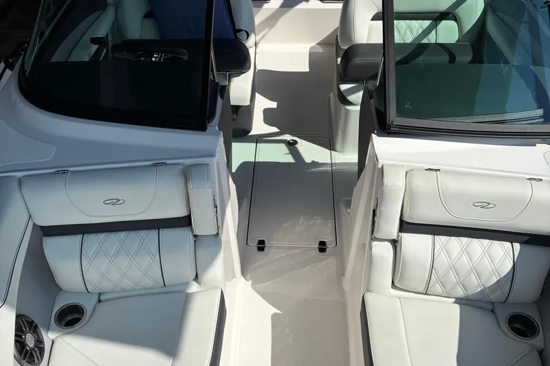 Slide: The Image of 2025 Regal LS2 boat interior with white leather seating and cup holders. - 19