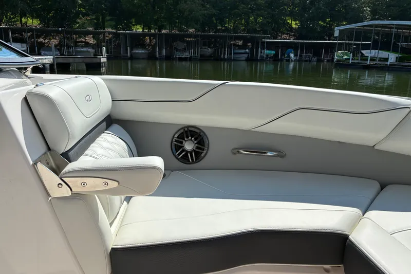 Slide: The Image of Luxurious interior of 2025 Regal LS2 boat with white leather seating and speaker. - 23