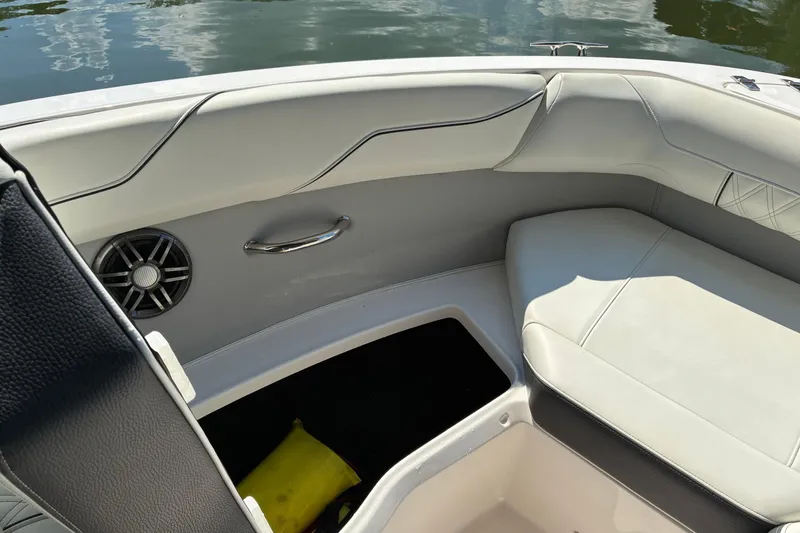 Slide: The Image of Interior of 2025 Regal LS2 boat with white seating and speaker detail. - 24