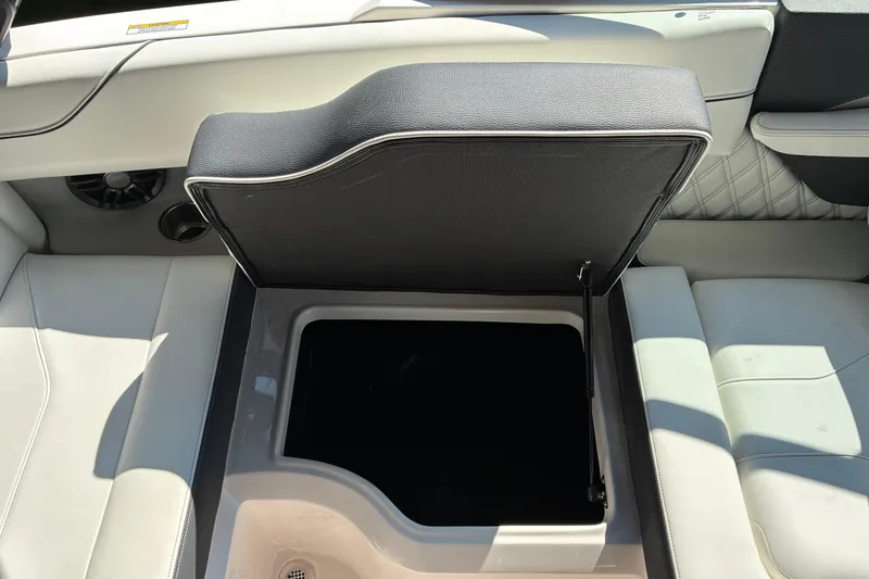 Slide: The Image of 2025 Regal LS2 boat interior storage compartment with open lid, showcasing sleek design. - 29