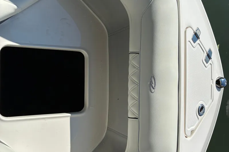 Slide: The Image of 2025 Regal LS2 boat interior with white cushioned seating and storage compartment. - 39