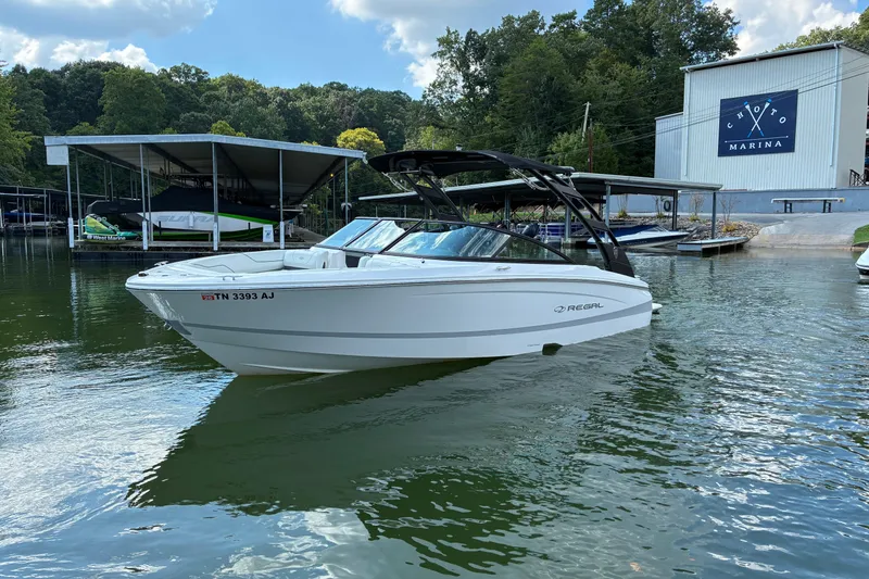 Slide: The Image of 2025 Regal LS2 boat docked at Choto Marina on a sunny day. - 4