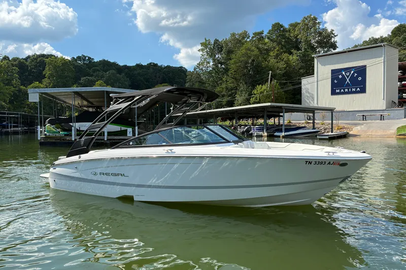 Slide: The Image of 2025 Regal LS2 boat docked at Choto Marina under a sunny sky. - 7