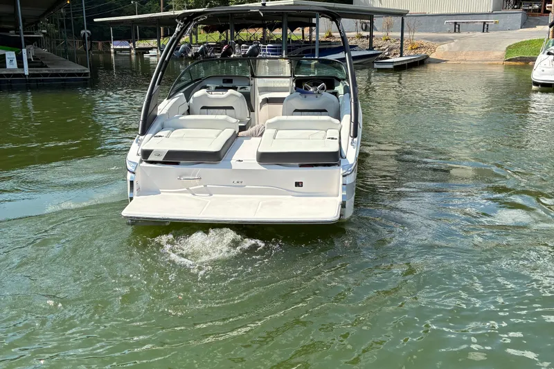 Slide: The Image of 2025 Regal LS2 boat on water, rear view with seating and canopy. - 8